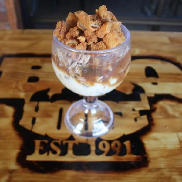 BBQ House Bar & Grill's BBQ parfait with pulled pork, mashed potatoes, gravy, and crispy fried onions.