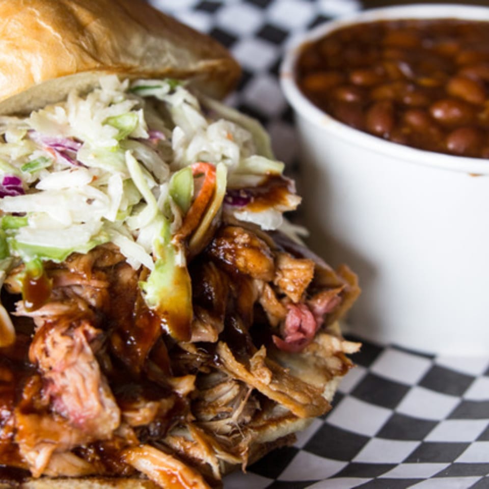 BBQ House Bar & Grill's pulled pork sandwich with coleslaw and a side of baked beans.