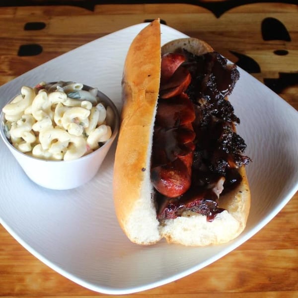 BBQ House Bar & Grill's BBQ sandwich with sausage and brisket, served with macaroni salad.